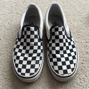 Checkered slip on vans.